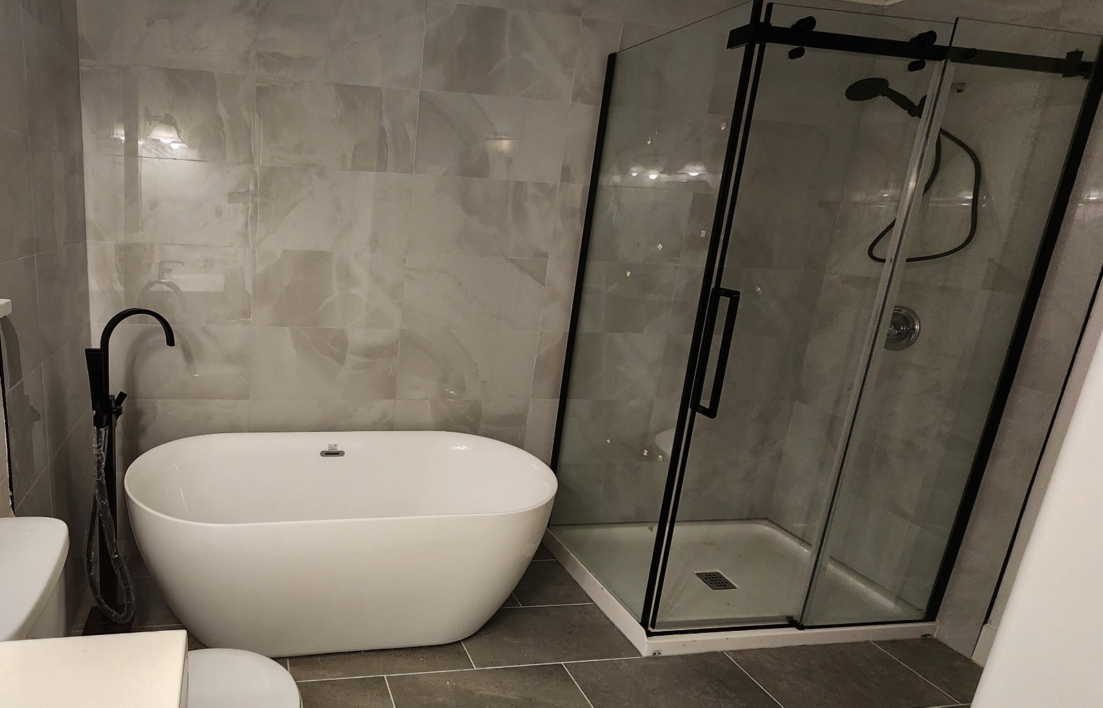 Bathroom after renovation — freestanding tub and glass shower