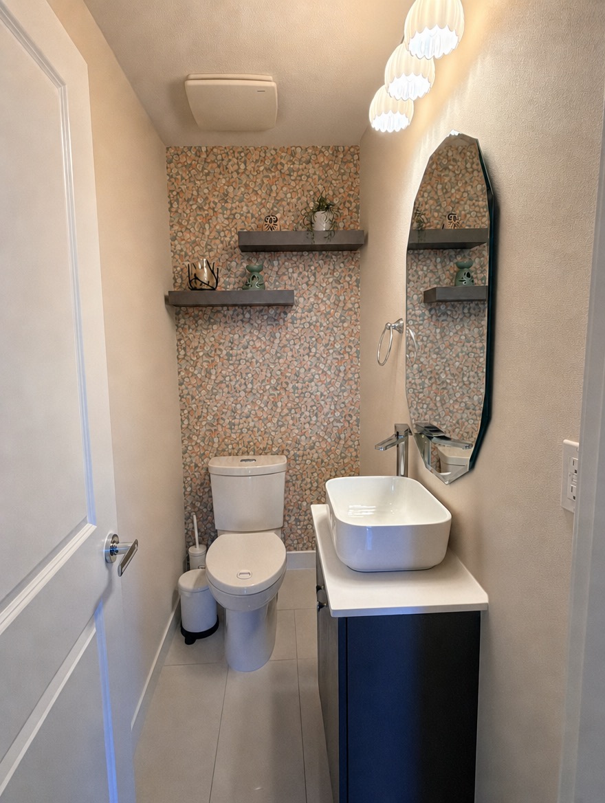 Powder room after renovation — pebble-pattern wallpaper and modern vanity