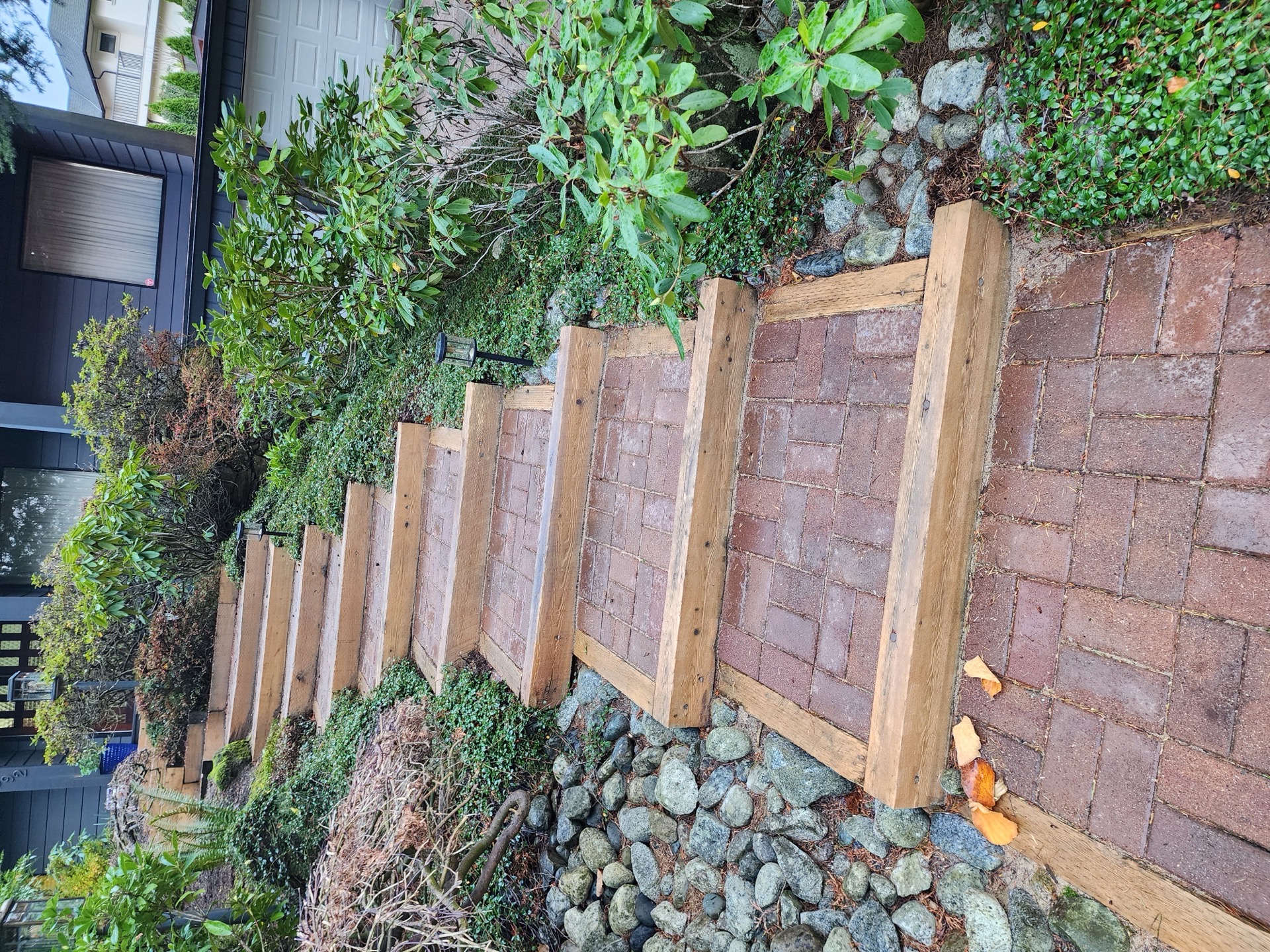 Paver steps before — bare pavers and wood trim, no railing
