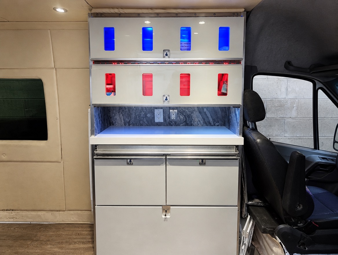 Van cabinetry after refresh — white lit cabinet system
